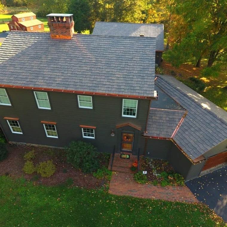 copper gutter installation with architectural shingles